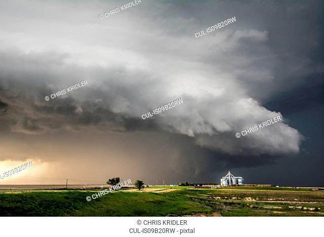 A tornado-producing supercell thunderstorm spinning over ranch land near Leoti, Kansas