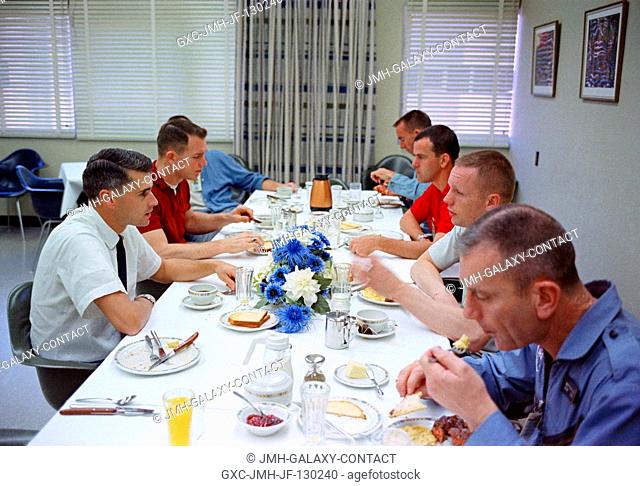 The Gemini-8 prime crew, along with several fellow astronauts, have a hearty breakfast of steak and eggs on the morning of the Gemini-8 launch