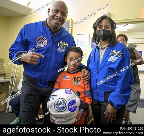 Former NASA astronaut Leland Melvin, left, and NASA astronaut Stephanie Wilson, pose for photograph with 6-year old Armani Bonds prior to the screening of the...