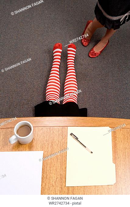 Office worker hiding under a desk
