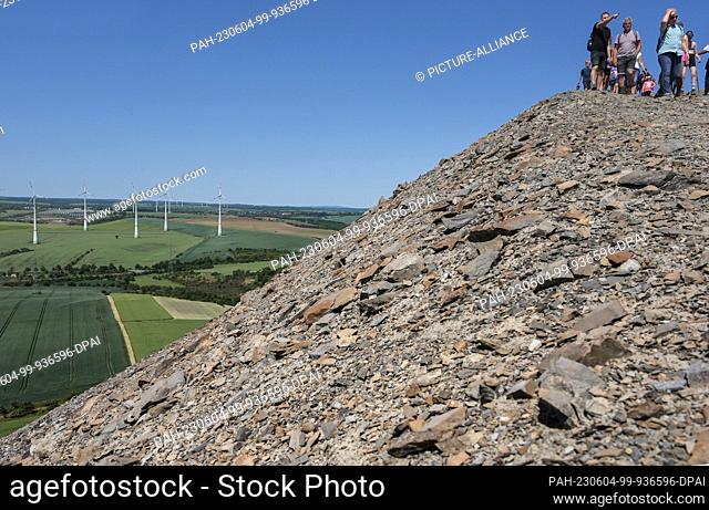 04 June 2023, Saxony-Anhalt, Volkstedt: Visitors during the stony descent from the tailings pile. The tailings pile belongs to the former ""Fortschritt"" copper...