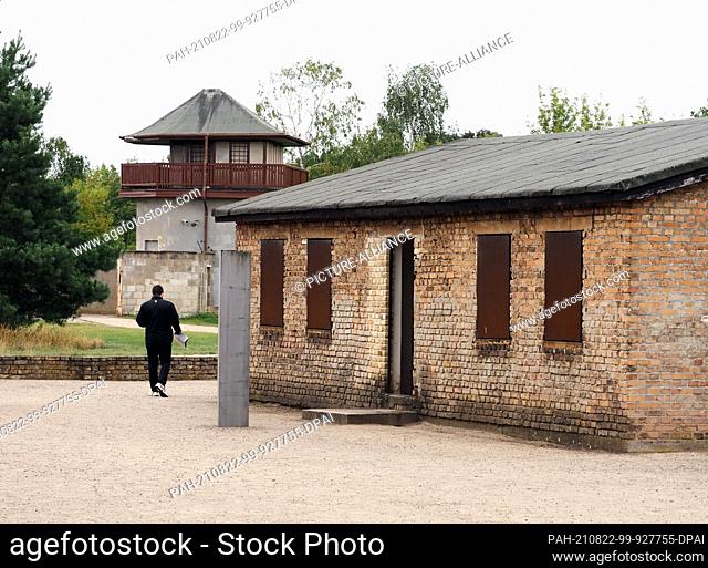 22 August 2021, Brandenburg, Oranienburg: A visitor walks past one of the brick barracks on the ""Soviet Special Camps"" museum grounds after the commemoration...