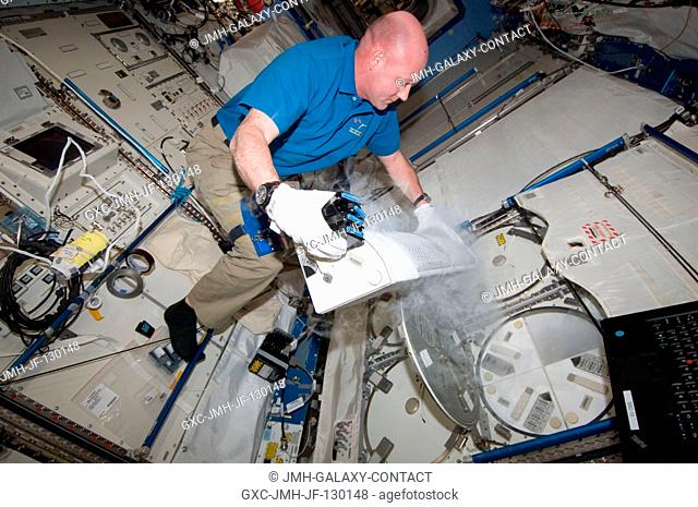 European Space Agency astronaut Andre Kuipers, Expedition 30 flight engineer, prepares to insert ESA Role of Apoptosis in Lymphocyte Depression 2 (ROALD-2)...