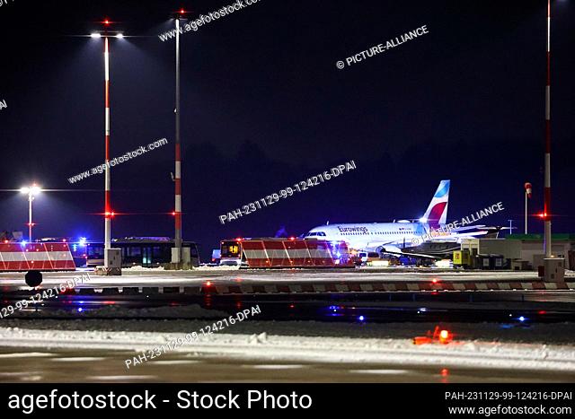 29 November 2023, Hamburg: A Eurowings aircraft is parked away from the terminals at Hamburg Airport. According to media reports