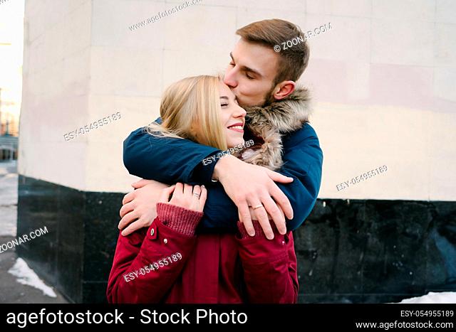 Young smiling happy european couple hugging in winter. Happy couple concept