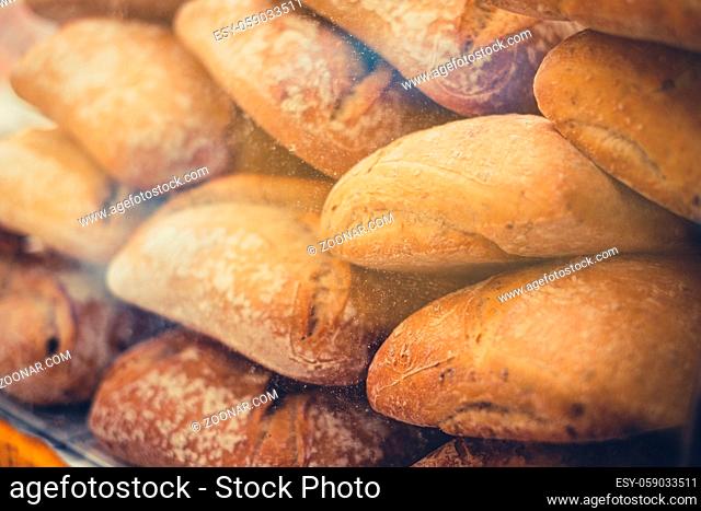 stack of fresh baguette bread closeup for sale at bakery