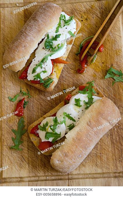 Toasted ciabattas filled with mozzarella, rocket and roasted peppers