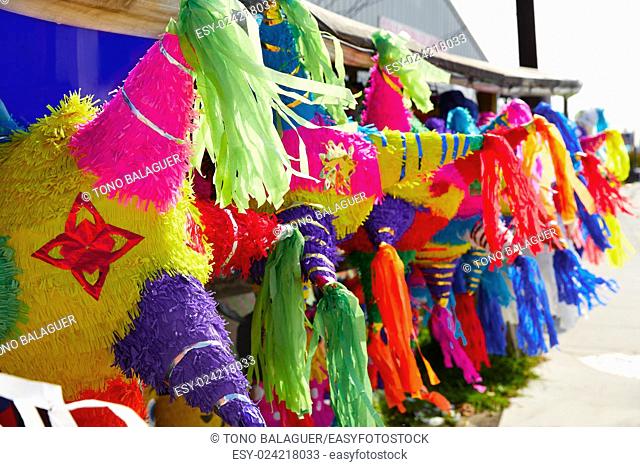 Mexican party pinatas decorated with fringed tissue colorful paper