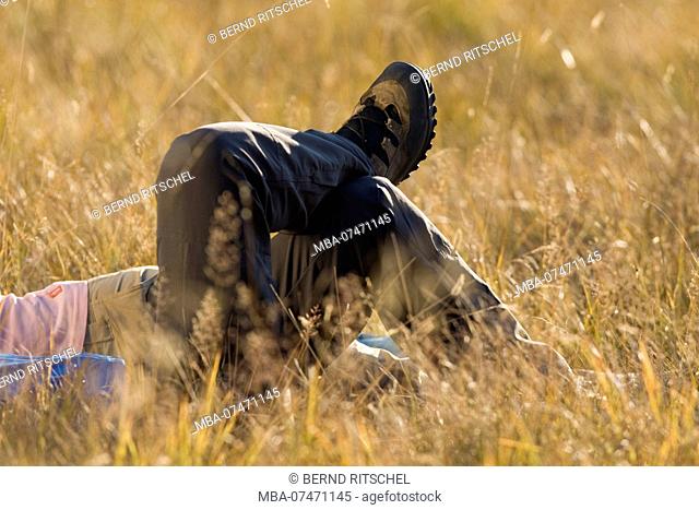 Hikers lying in the grass, close-up, Lungau, Salzburger Land, Austria