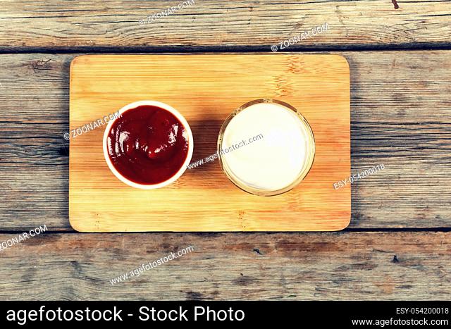 Ketchup and mayonnaise in serving dishes, restaurant, cafe, fast food. top veiw