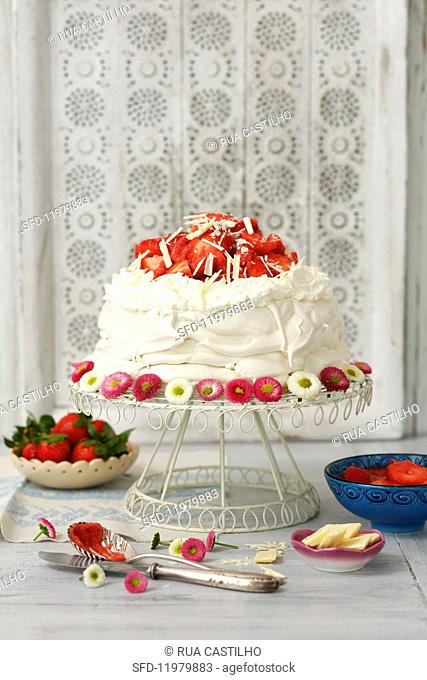 Pavlova with whipped cream and strawberries