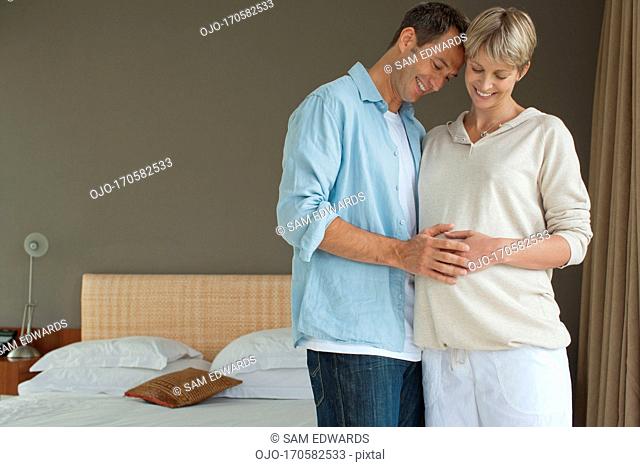 Husband touching pregnant wife’s stomach