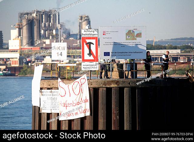 07 August 2020, North Rhine-Westphalia, Cologne: Environmental activists block the port access to the Shell refinery Wesseling in the Godorf Rhine port