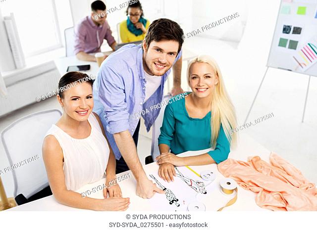 team of fashion designers working at office