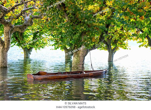 Boat on a flooding, Maggiore with trees in Ascona, Switzerland