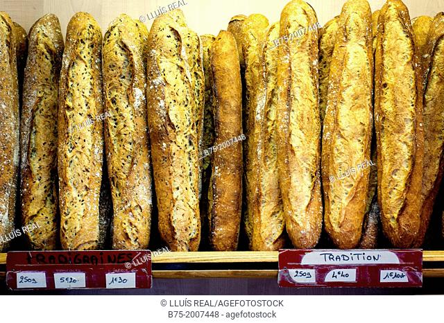 Shelf of a bakery with many traditional baguettes in Paris, France, Europe