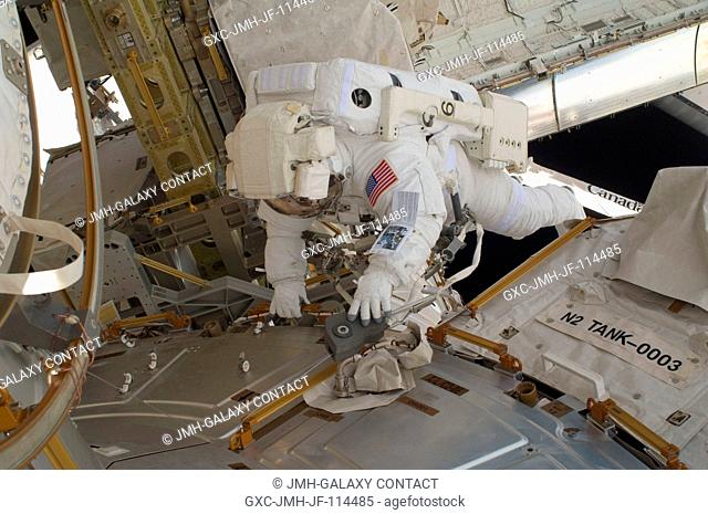 NASA astronaut Nicholas Patrick, STS-130 mission specialist, participates in the mission's first session of extravehicular activity (EVA) as construction and...