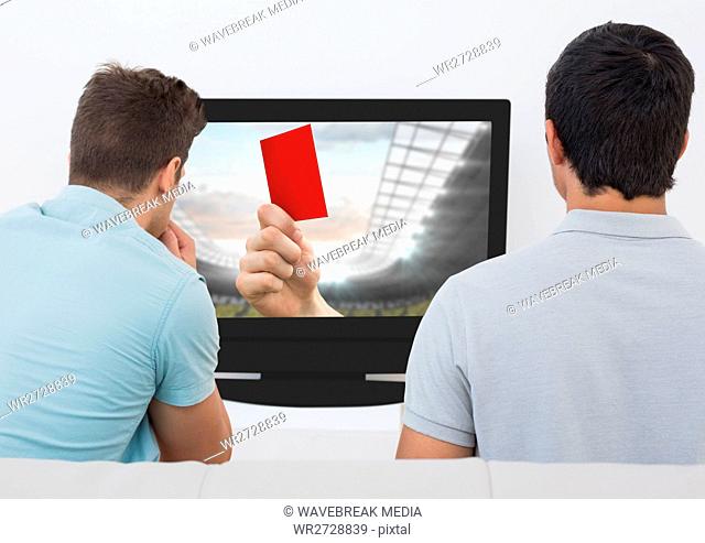 Rear view of men watching television in living room