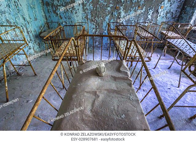 Infant cribs in Hospital No. 126 of Pripyat ghost city, Chernobyl Nuclear Power Plant Zone of Alienation around nuclear reactor disaster, Ukraine