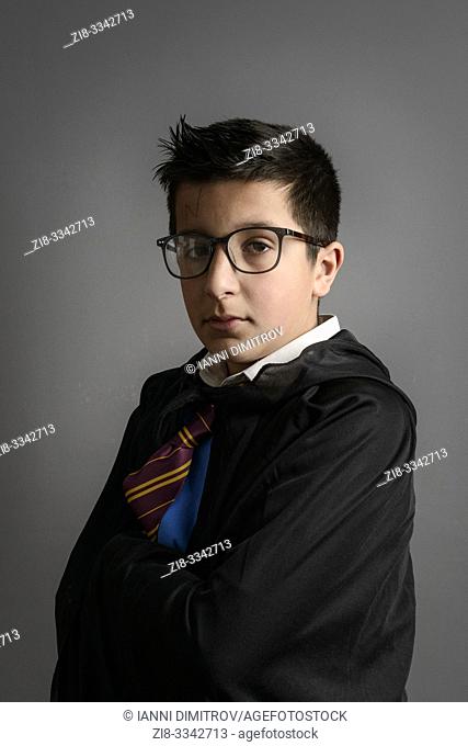 Caucasian schoolboy- 11 years old, in Harry Potter party costume, Studio shot