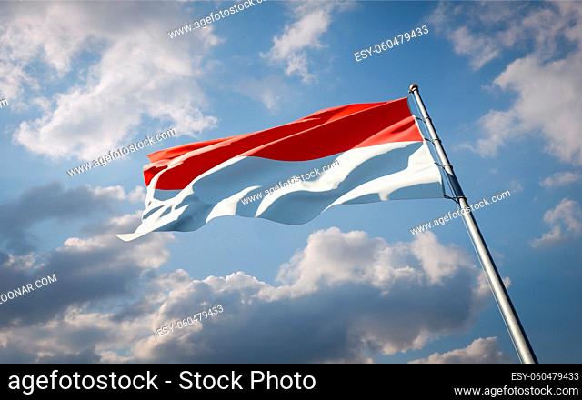 Beautiful national state flag of Indonesia fluttering at sky background. Low angle close-up Indonesia flag 3D artwork
