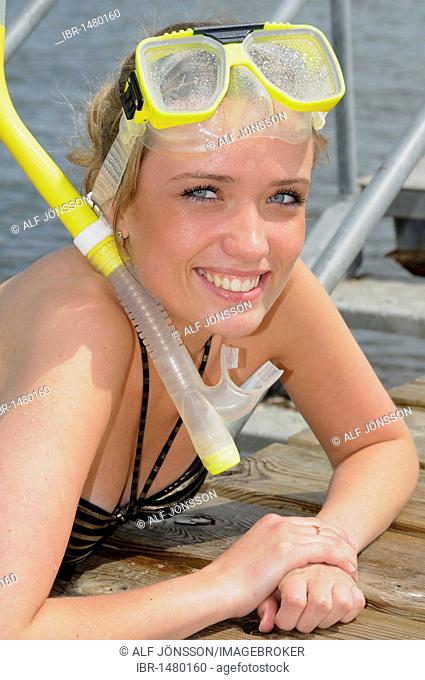 Girl in bathing suit and with goggles and snorkel