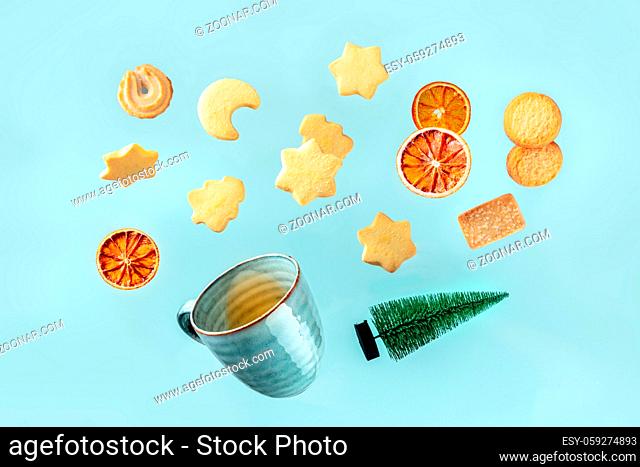 Various Danish butter cookies with tea and a Christmas tree, a creative Christmas greeting card design with tasty biscuits