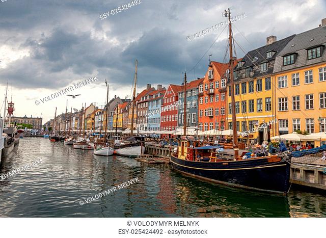 The boats and ships in the calm hurbour of Nyhavn, Copenhagen, Denmark. Nyhavn is waterfront, canal and entertainment district in Copenhagen
