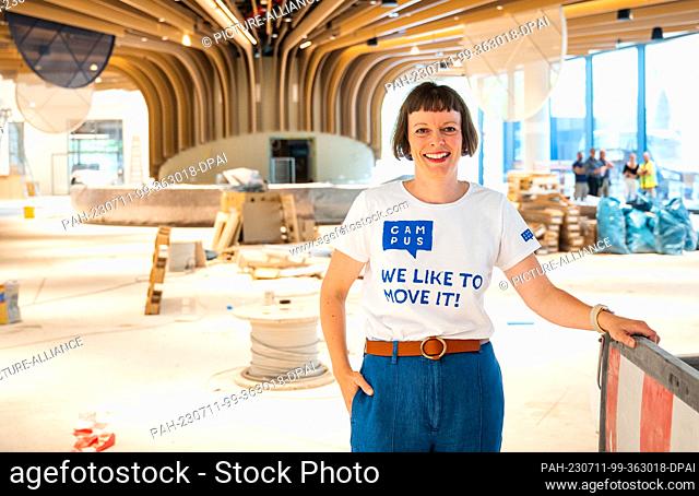 11 July 2023, Hamburg: Marie Boden, project manager for Beiersdorf's new campus, stands in a café on the construction site