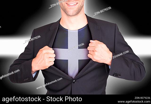 Businessman opening suit to reveal shirt with flag, Cornwall