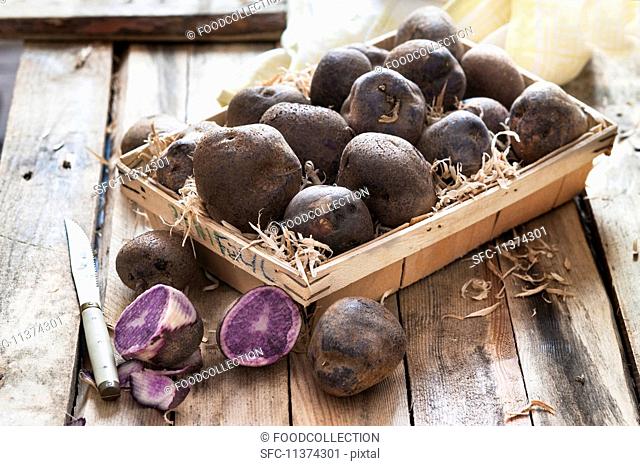 Purple potatoes in a wooden basket