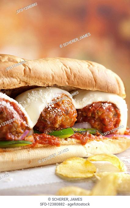A meatball sub sandwich cheese and tomato sauce