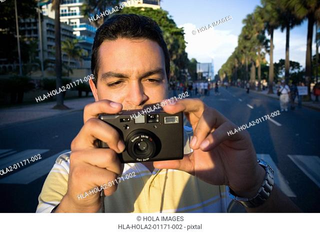 Mid adult man holding a camera