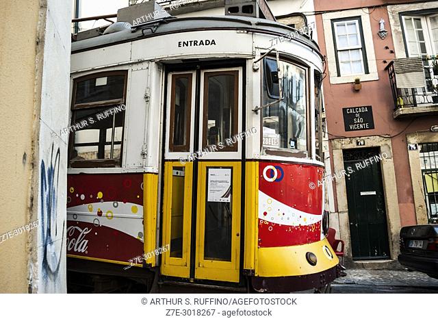 Tram negotiating the narrow, cobblestone streets of Lisbon's Alfama district. Lisbon, Portugal, Europe