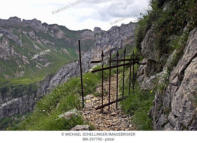 Mountain way with iron cattle gate in the Alpsteingebirge Canton Appenzell, Switzerland