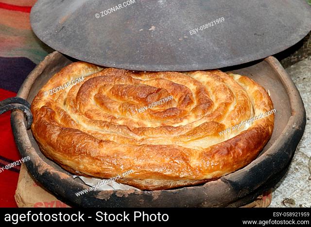 Freshly baked homemade bread arranged in traditional Bulgarian textiles. Image of some tasty Home-made bakery products