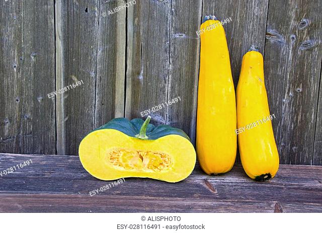 yellow zucchini and slice green fresh pumpkin on old wooden background