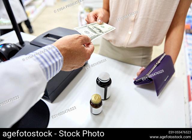 pharmacist taking money from customer at pharmacy