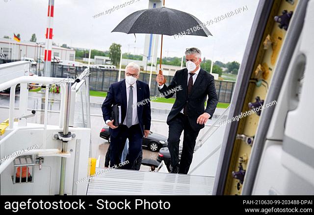 30 June 2021, Berlin: Federal President Frank-Walter Steinmeier (l) walks to the Air Force Airbus A350 on the military section of BER Berlin Brandenburg Airport...