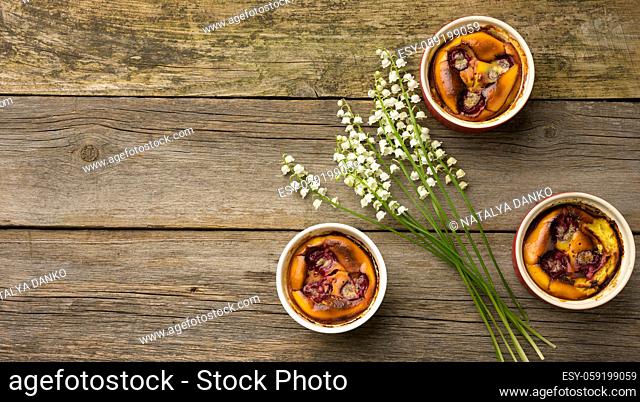 cottage cheese dessert baked in portioned round ceramic plates on a wooden table, top view, copy space