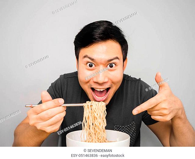 Asian man feel surprise with how delicious instant noodle is