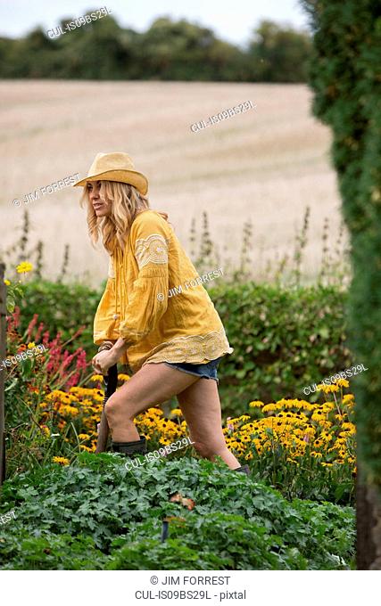 Woman working on garden in countryside