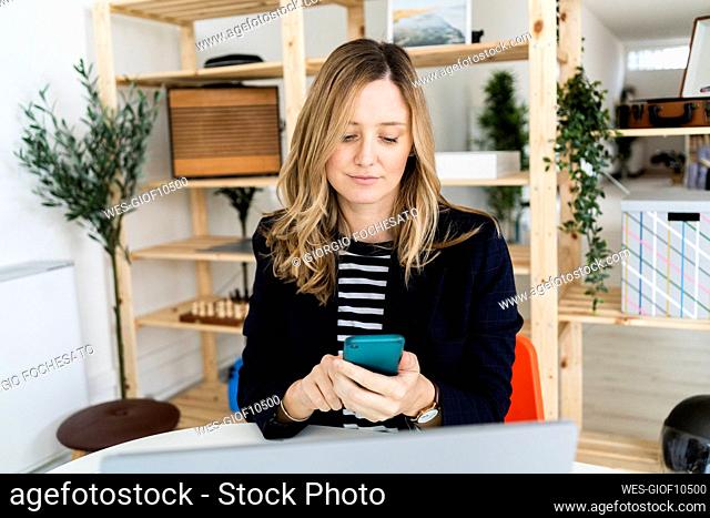 Business woman using smart phone in office