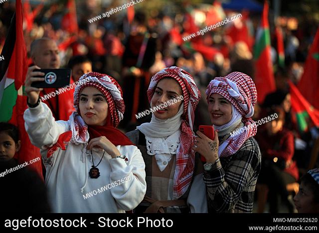 Palestinian supporters of the Popular Front for the Liberation of Palestine (PFLP) wear checkered 'kafiyeh' headdresses, as they celebrate at the Gaza city