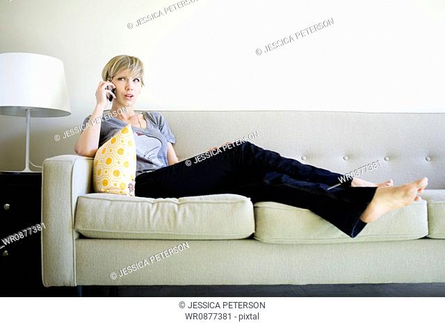 woman on the couch using cell phone