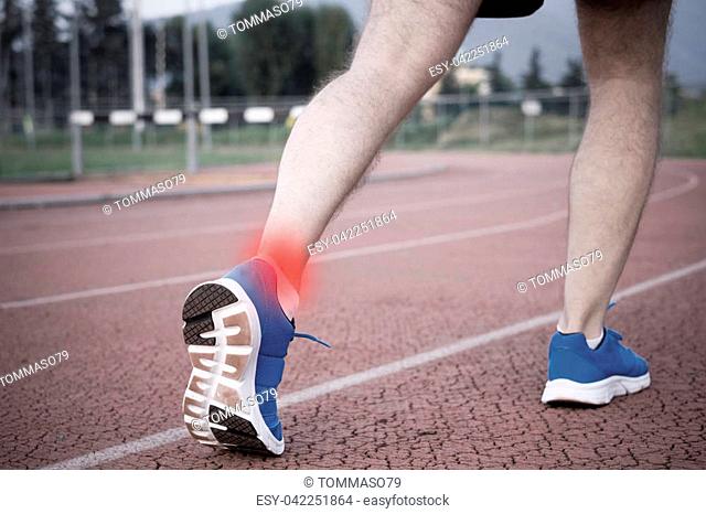 Runner with injured ankle on the track