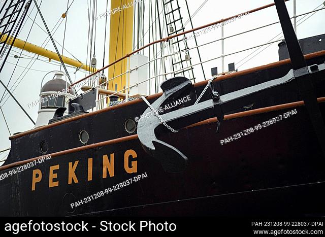 08 December 2023, Hamburg: The newly attached anchor of the four-masted barque and museum ship ""Peking"" can be seen next to the name lettering on the hull in...