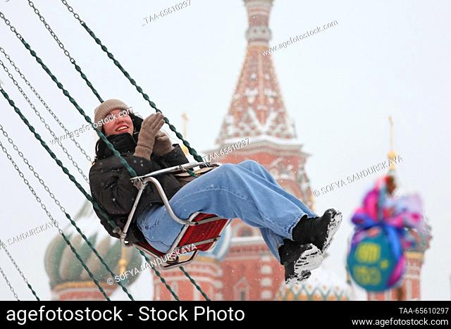 RUSSIA, MOSCOW - DECEMBER 10, 2023: A girl on a carousel in Red Square with St Basil's Cathedral in the background. Sofya Sandurskaya/TASS