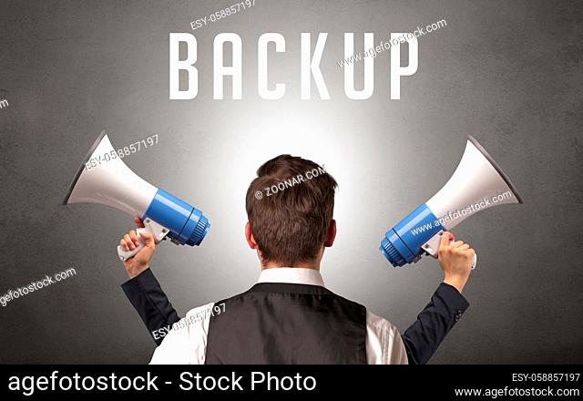 Rear view of a businessman with BACKUP inscription, cyber security concept