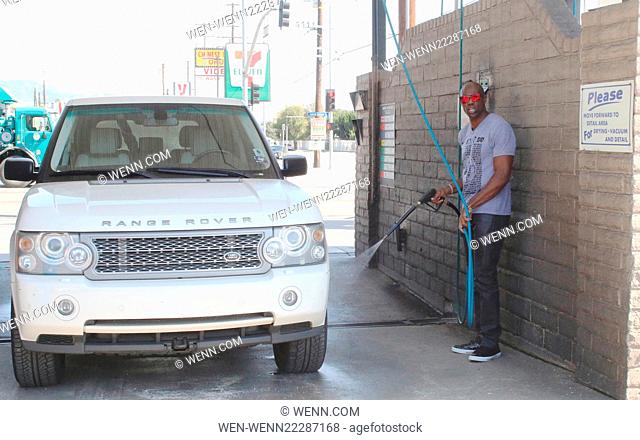 Terrell Owens washing his car at a public car wash in Sherman Oaks. After getting wet Owens took off his shirt, revealing his six-pack